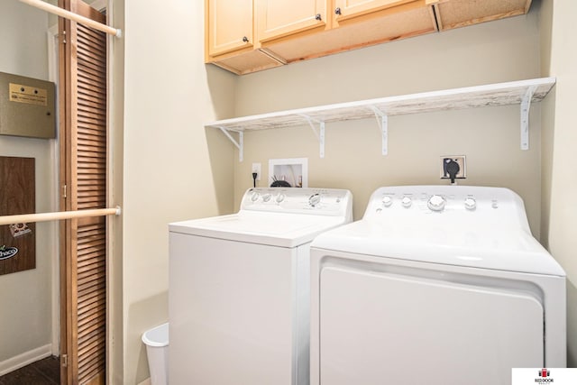 laundry room with independent washer and dryer and cabinets