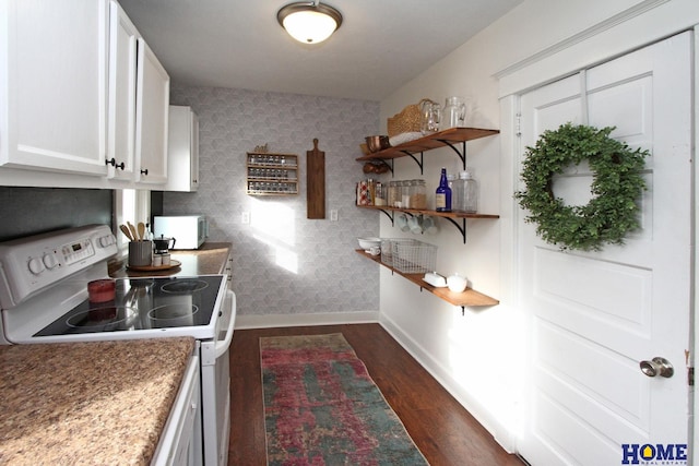 kitchen with light stone counters, white appliances, dark hardwood / wood-style floors, and white cabinets