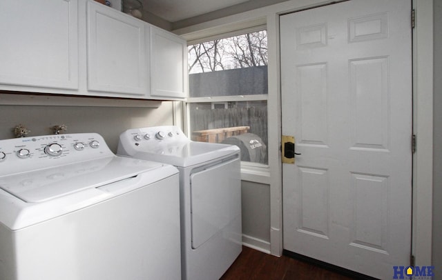 laundry area featuring dark wood-type flooring, cabinets, and washing machine and clothes dryer