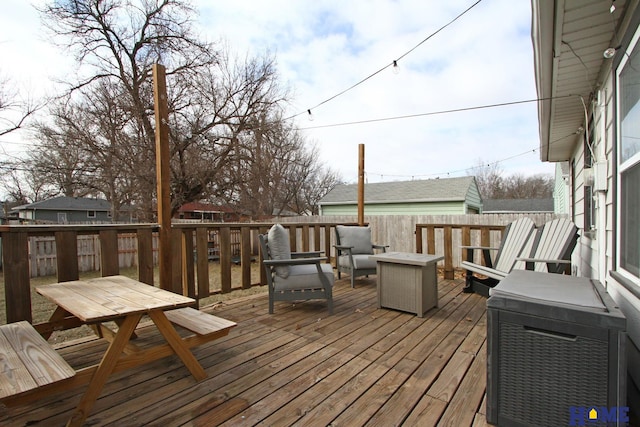 wooden deck featuring an outdoor fire pit