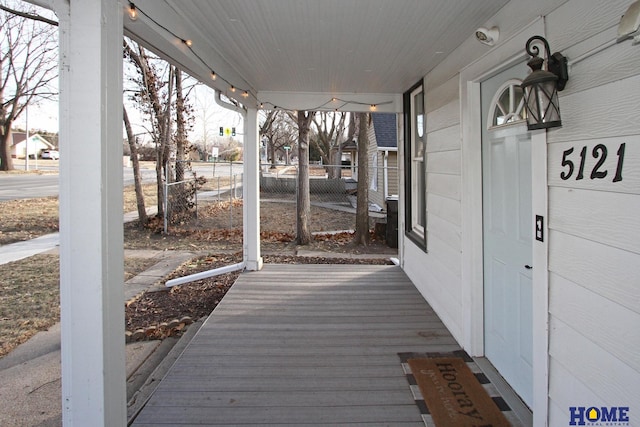 wooden terrace featuring covered porch