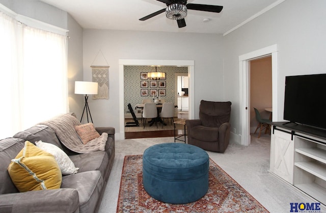 carpeted living room with ceiling fan