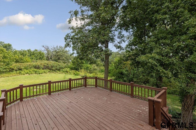 wooden terrace featuring a yard