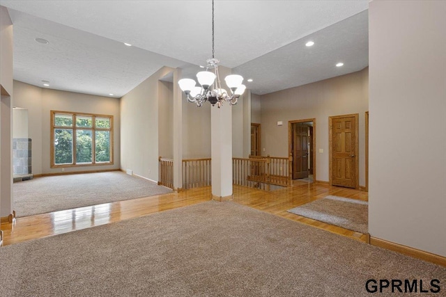 interior space featuring light carpet and an inviting chandelier