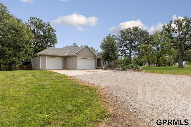 view of front of property with a garage and a front lawn