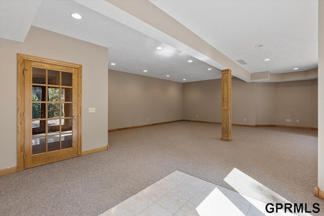 basement featuring light carpet