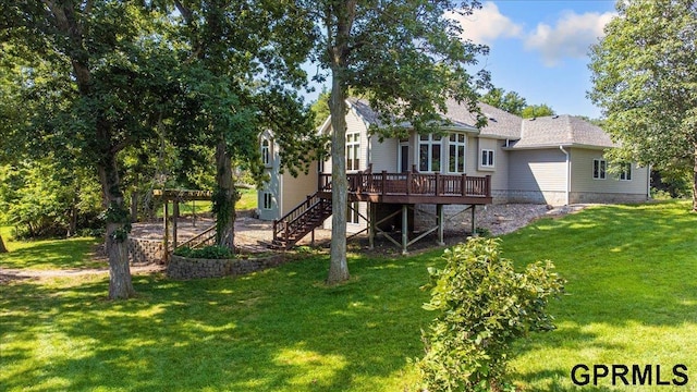 rear view of property with a wooden deck and a yard