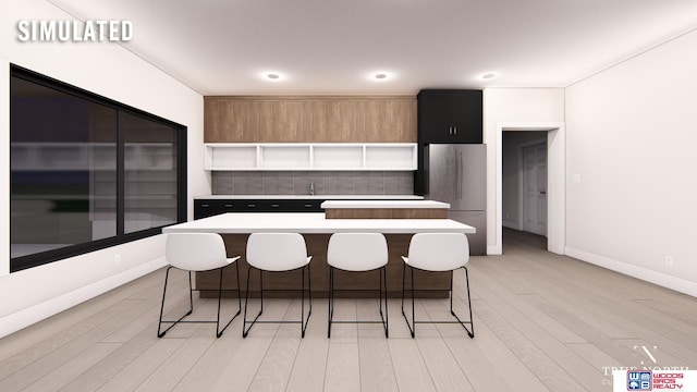 kitchen with stainless steel refrigerator, a kitchen breakfast bar, and a kitchen island