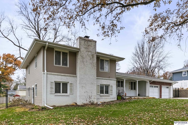 view of front of property with a garage and a front yard