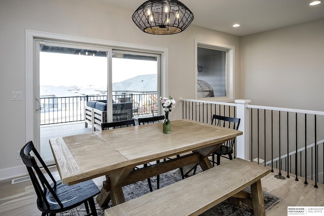 dining space featuring a notable chandelier, a mountain view, and light wood-type flooring