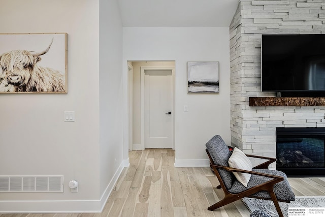 interior space featuring a fireplace and light hardwood / wood-style floors