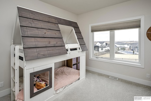 bedroom featuring light colored carpet