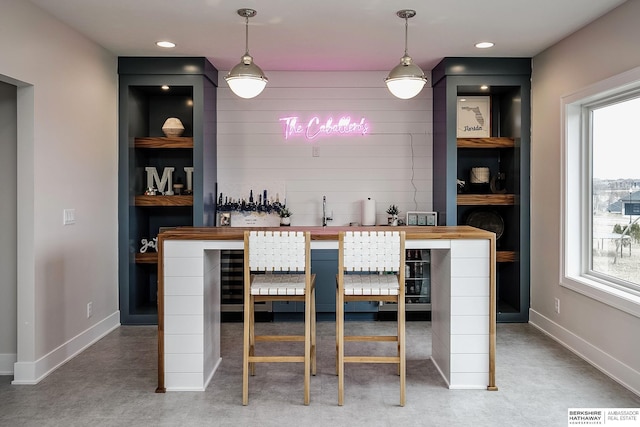 bar featuring pendant lighting and built in shelves