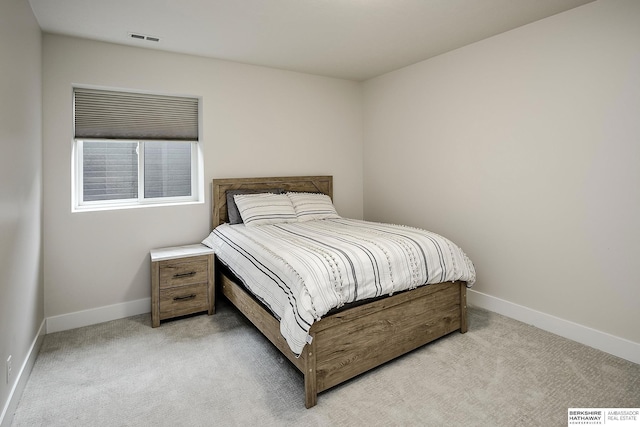 bedroom featuring light carpet