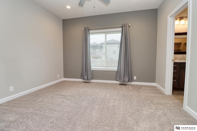 carpeted empty room with ceiling fan