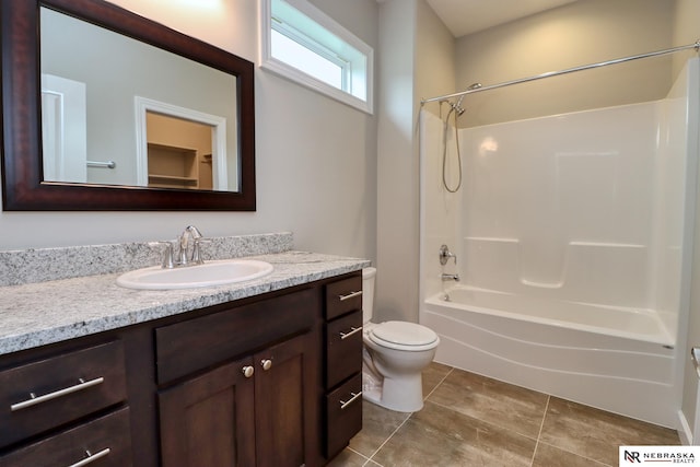 full bathroom with vanity, toilet, and  shower combination