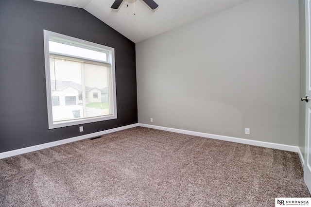 empty room with lofted ceiling, carpet floors, and ceiling fan