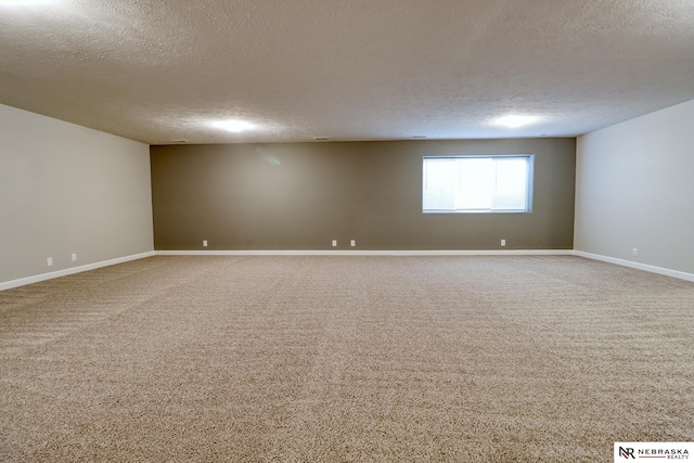 empty room with carpet flooring and a textured ceiling