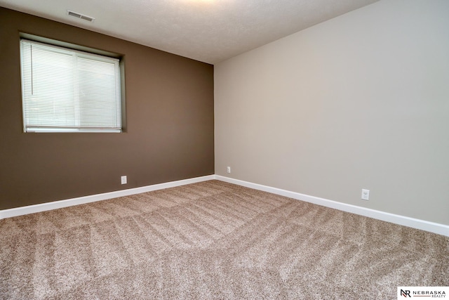 spare room featuring carpet