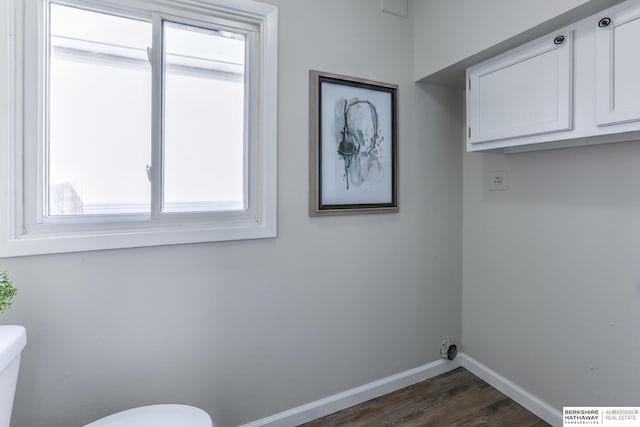 washroom featuring dark wood-type flooring and hookup for an electric dryer