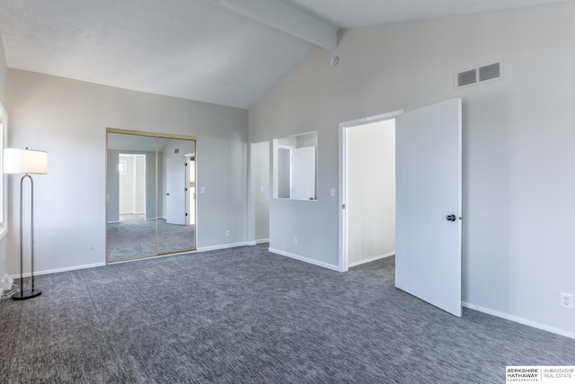 carpeted spare room featuring beam ceiling and high vaulted ceiling