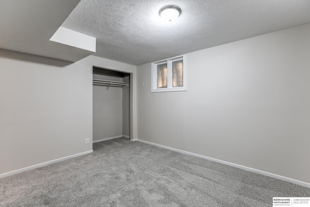 unfurnished bedroom featuring carpet flooring, a closet, and a textured ceiling