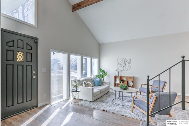 foyer featuring hardwood / wood-style floors, beam ceiling, and high vaulted ceiling