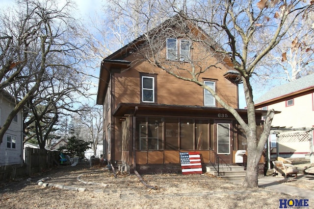 view of front of property featuring a sunroom