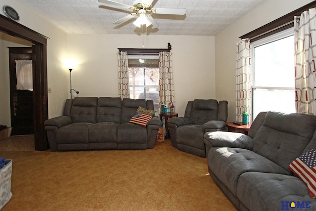 living room featuring light colored carpet and ceiling fan