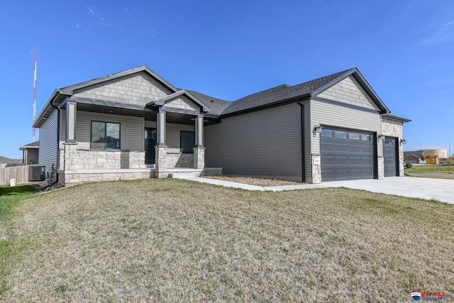 craftsman inspired home featuring a garage, covered porch, a front yard, and central air condition unit