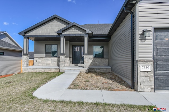 view of front of house with a porch and a front yard