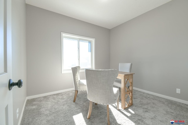 dining space featuring light carpet