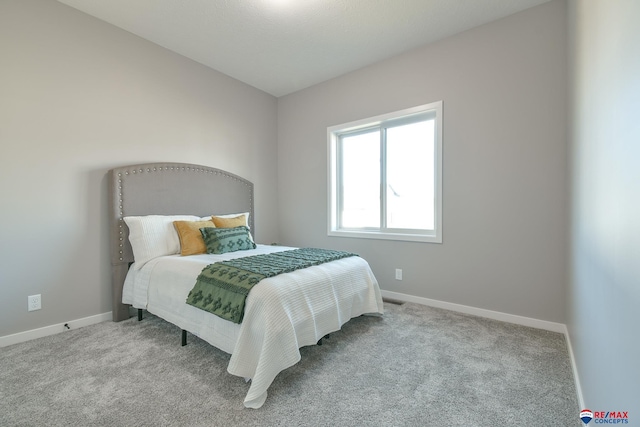 bedroom with light colored carpet