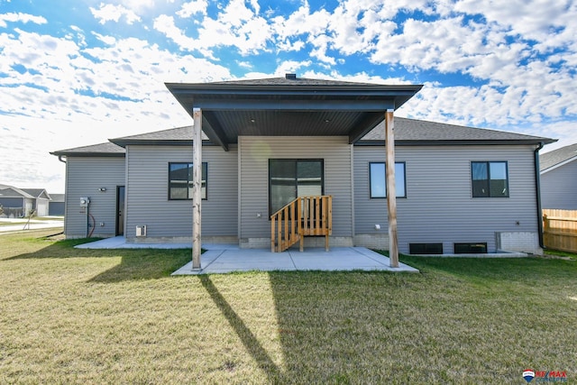 back of house with a lawn and a patio area