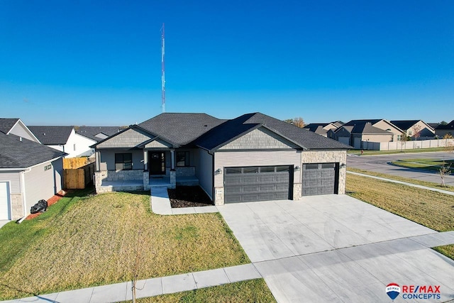 view of front of property featuring a garage and a front lawn