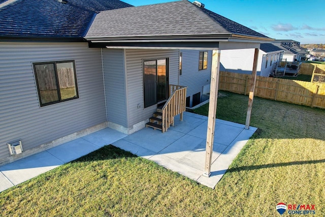 rear view of house with a yard and a patio