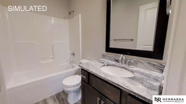 full bathroom with bathing tub / shower combination, hardwood / wood-style floors, vanity, and toilet