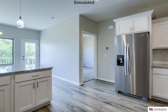 kitchen featuring stainless steel refrigerator with ice dispenser, light stone countertops, light hardwood / wood-style floors, white cabinets, and decorative backsplash