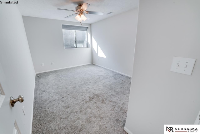 unfurnished room with ceiling fan and carpet