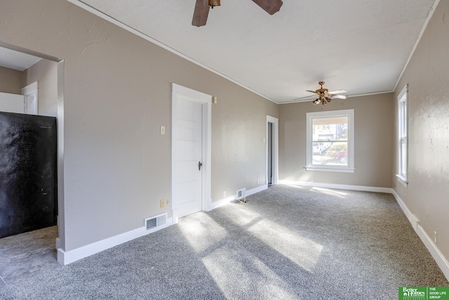 carpeted spare room with ornamental molding and ceiling fan