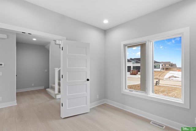 unfurnished room featuring light wood-type flooring