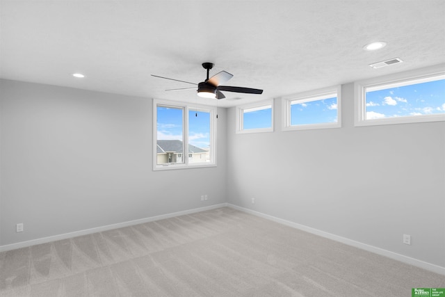 carpeted spare room with ceiling fan