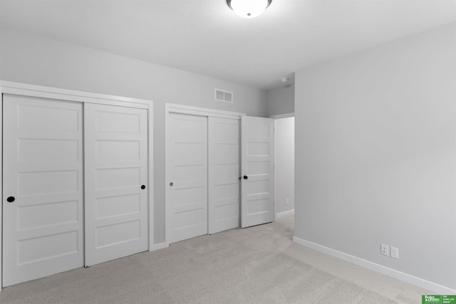 unfurnished bedroom with light carpet