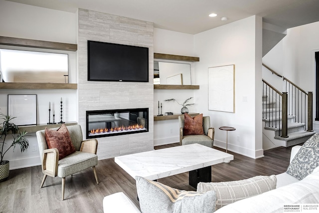 living room featuring dark hardwood / wood-style flooring and a fireplace