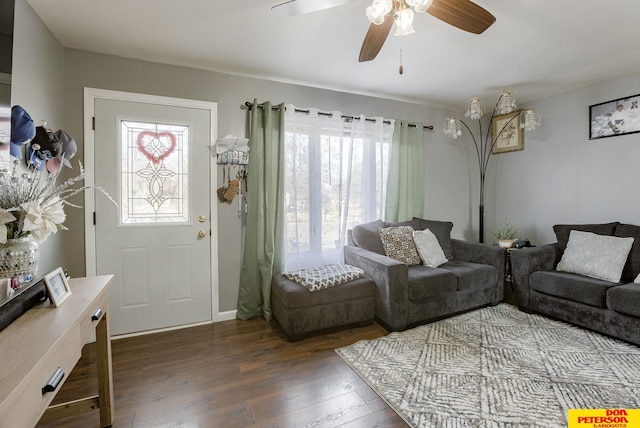 living room featuring dark wood-type flooring, ceiling fan, and plenty of natural light