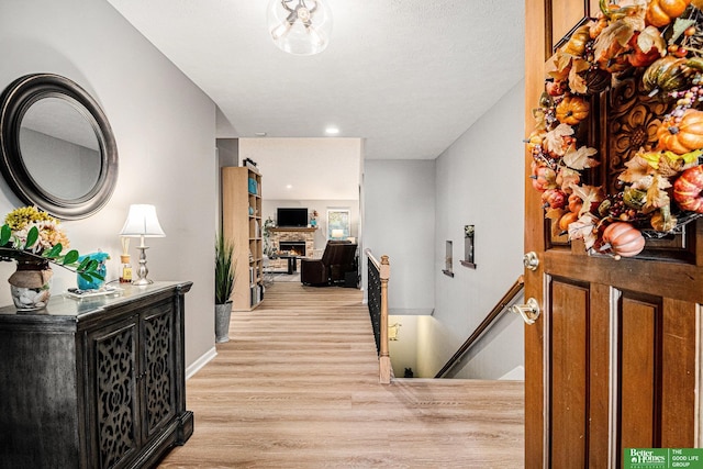 corridor with light hardwood / wood-style flooring