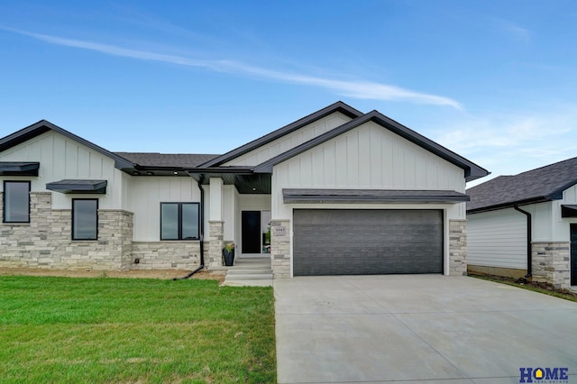 view of front of home with a garage and a front lawn