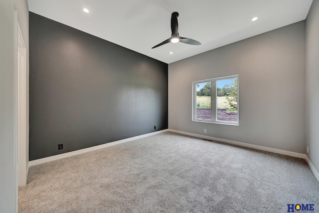 spare room with light colored carpet and ceiling fan