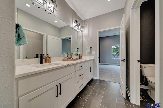 bathroom featuring tile patterned floors, vanity, and toilet