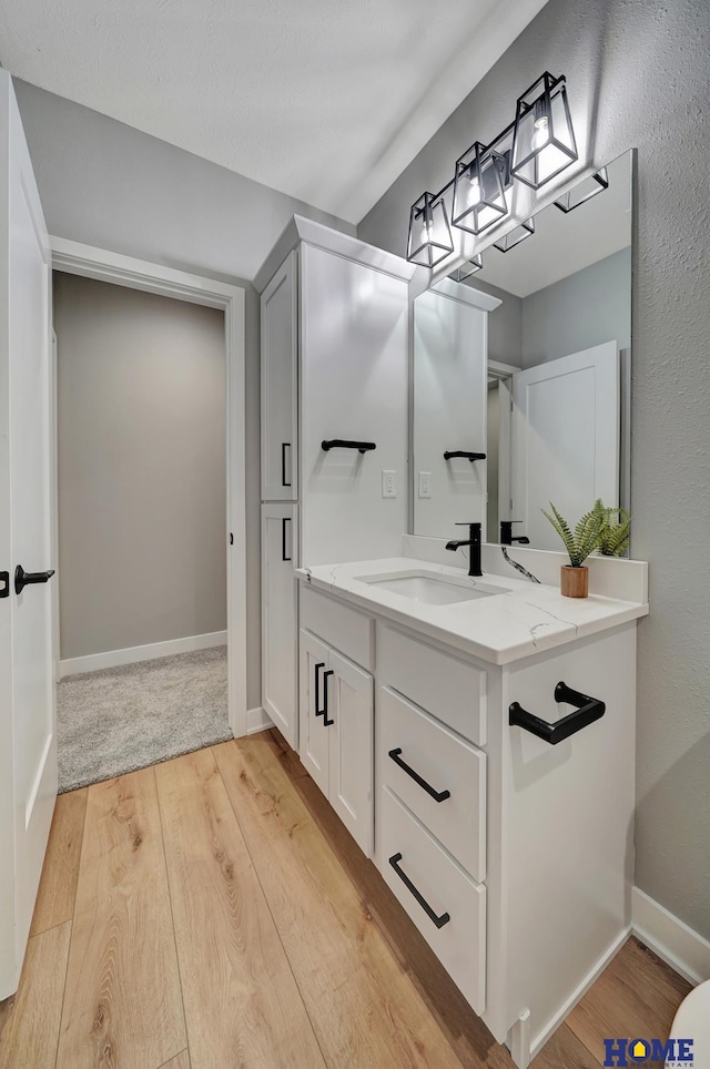 bathroom with vanity and hardwood / wood-style floors